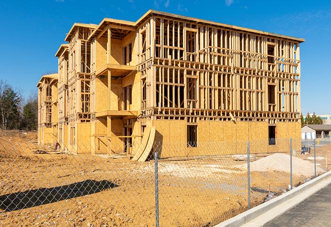 a temporary chain link fence in front of a building under construction, ensuring public safety in South Pekin, IL